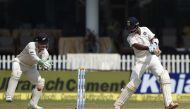 New Zealand's wicket keeper BJ Watling (L) watches as India's Cheteshwar Pujara plays a shot during the fourth day of the first Test match between India and New Zealand at Green Park Stadium in Kanpur on September 25, 2016. (AFP / PRAKASH SINGH)