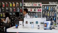 Customers queue near Galaxy Note 7 smartphone advertisements at a Samsung service centre in Taipei, Taiwan October 11, 2016. REUTERS/Tyrone Siu