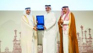 HE Dr. Mohammed bin Saleh Al Sada, Minister of Energy and Industry giving away an award to Mohamed Al Mushiri, ORYX GTL Chief Commercial Officer at the event yesterday; while Abdulaziz bin Hamad Al Ageel looks on. Pic: Baher Amin / The Peninsula