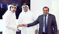 An IIA official receiving the licence from QFC Authority officials. 