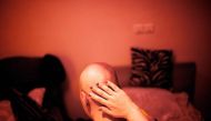 (FILES) This file photo taken on October 18, 2013 shows Iranian breast cancer patient Farvah posing for a portrait in a studio in Tehran.   AFP / BEHROUZ MEHRI