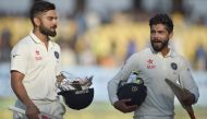 India's captain Virat Kohli (L) and Ravindra Jadeja walk back at the end of play on the fifth day of the first Test cricket match between India and England at the Saurashtra Cricket Association stadium in Rajkot on November 13, 2016. (AFP / Indranil Mukhe