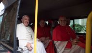 Pope Francis sits in a bus with the new cardinals as they travel to meet Pope Emeritus Benedict XVI following a consistory ceremony in Saint Peter's Basilica at the Vatican November 19, 2016. (Osservatore Romano Handout via Reuters)