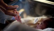 REPRESENTATIVE IMAGE: A man touches his newborn baby born three days earlier at the Israeli hospital in Port-au-Prince, January 20, 2010. (REUTERS /Carlos Garcia Rawlins) 