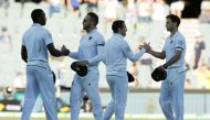 South African captain Faf du Plessis (2nd L) shakes hands with team mate Kagiso Rabada (L) as Dean Elgar shakes hands with Stephen Cook at the end of the fourth day of the Third Test cricket match. (REUTERS/Jason Reed)