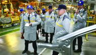 French Finance Minister Michel Sapin visits the assembly department of a plant of French multinational automobile manufacturer Renault in Moscow, yesterday.