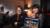 MEANS Database's Maria Rose Belding, co-founder and executive director, right, along with Grant Nelson, chief operating officer, pose for a photo with their homepage visible on the screen in their office at American University on December 4, 2015 in Washi