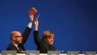 German Chancellor and leader of the conservative Christian Democratic Union party CDU Angela Merkel and CDU secretary general Peter Tauber (L) vote during the CDU party convention in Essen, Germany, December 7, 2016. REUTERS/Kai Pfaffenbach

