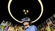 (FILES) This file photo taken on March 02, 2016 shows a man wearing headphones and VR glasses to watch films at the Virtual Reality cinema in Amsterdam, on March 2, 2016. AFP / ANP / Sander Koning