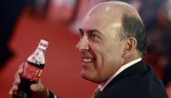 Chief Executive Officer and Chairman of Board of the Coca Cola Company Muhtar Kent holds a Coca-Cola bottle that is made in a Coca-Cola factory in Myanmar, during the factory's opening ceremony, outside of Yangon June 4, 2013. REUTERS/Soe Zeya Tun