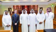 Judge Dr Hassan Al Sayed (second right) and the visiting UAE delegation with QICDRC judges  and officials in Doha recently. 
