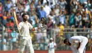 India's captain Virat Kohli celebrates after scoring a double century (200 runs) on the fourth day of the fourth Test cricket match between India and England at the Wankhede stadium in Mumbai on December 11, 2016. GETTYOUT / AFP / PUNlT PARANJPE /