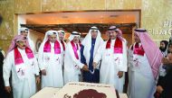 Hussain Ibrahim Al Fardan (third right), Vice Chairman and Managing Director of the Board of Commercial Bank, with other board members and staff at the cake cutting ceremony, which was made in the shape of the map of Qatar at the bank's headquarters in Do