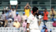 India's Lokesh Rahul kisses his helmet as he celebrates after scoring a century (100 runs) during the third day of the fifth and final Test cricket match between India and England at The M.A. Chidambaram Stadium in Chennai on December 18, 2016. (AFP / ARU
