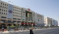 A man crosses Grand Hamad street where banks and financial institutions are located in Doha, Qatar (Reuters)