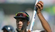 India's Ravichandran Ashwin celebrates during a victory lap after winning the fourth Test cricket match against England at the Wankhede stadium in Mumbai on December 12, 2016. (AFP / PUNlT PARANJPE)