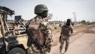 Soldiers of the 7th Division of the Nigerian Army stand by the road in Damboa, Borno State, northeast Nigeria on March 25, 2016 (AFP / STEFAN HEUNIS) 