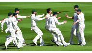 Australian players rush to embrace team-mates Josh Hazlewood (2right) and David Warner (right) after Australia defeated Pakistan on the final day of the second cricket Test match in Melbourne, Australia yesterday.