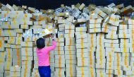 Singles' Day is a Chinese annual online shopping spree that has been held every November 11 since 2009. Picture shows an employee stacking the packets in an online store.