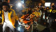 First aid officers carry an injured woman at the site of an armed attack on January 1, 2017 in Istanbul. At least two people were killed in an armed attack Saturday on an Istanbul nightclub where people were celebrating the New Year, Turkish television re