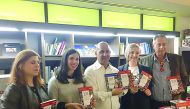 Ali Mushaima (centre) of Arab World Tours, and other officials at the book launch ceremony in Athens. 
