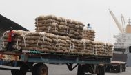 In January 2011, an Ivorian worker stands on a truck carrying bags of cocoa beans, 15 percent of Ivory Coast's GDP and more than 50 percent of its export earnings, according to the World Bank (AFP Photo/ISSOUF SANOGO)