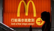 FILE PHOTO - A woman walks past a McDonald's outlet in Hong Kong in this July 25, 2014 file photo. REUTERS/Tyrone Siu/Files Photo
