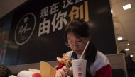 A Chinese customer eats a meal at a McDonald's fast food restaurant in Beijing on January 9, 2017. AFP / NICOLAS ASFOURI
