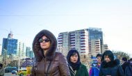 People walking in the street on their way to work in Beijing yesterday. Chinese exports fell more than expected in December, data showed yesterday, deepening concerns about the trade outlook for the world's number-two economy as Donald Trump prepares to t