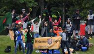 Bangladesh fans celebrate New Zealand's Mitchell Santner being caught with LBW during day two of the second international Test cricket match between New Zealand and Bangladesh at Hagley Park Oval in Christchurch on January 21, 2017. (AFP / Marty Melville)