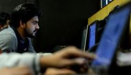 In this photograph taken on December 13, 2016, an employee of Indian IT security solutions company Innefu Labs works at their offices in New Delhi. AFP / SAJJAD HUSSAIN 