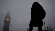 Fog surrounds a statue of Winston Churchill in front of Big Ben and the Houses of Parliament in London, Britain, January 23, 2017. REUTERS/Toby Melville
