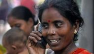 Tulsi Prasad, an Indian slum dweller, uses a mobile phone in the eastern Indian city of Kolkata, August 23, 2005 (Reuters)