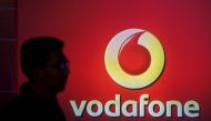 A man casts silhouette onto an electronic screen displaying logo of Vodafone India after a news conference to announce the half year results in Mumbai, India. (REUTERS/Shailesh Andrade/File Photo)