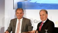 Etihad Aviation Group CEO James Hogan (R) and Carsten Spohr, Chief Executive Officer of Lufthansa, sign a deal in Abu Dhabi, United Arab Emirates February 1, 2017. REUTERS/Stringer
