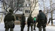 Ukrainian servicemen look at a building destroyed as a result of night shelling by pro-Russian separatists to the flashpoint eastern town of Avdiivka, north of the pro-Russian rebels' de facto capital of Donetsk, on February 3, 2017. AFP / Aleksey FILIPPO