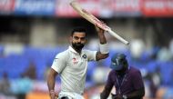 India's Virat Kohli gestures to the stands as he walks back to the pavilion at stumps on the first day of the Test cricket match between India and Bangladesh at The Rajiv Gandhi International Cricket Stadium in Hyderabad on February 9, 2017. (AFP / NOAH S