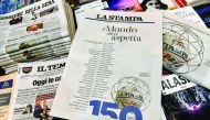 A photo taken on February 9, 2017 shows a copy of the 150th anniversary edition of Italian newspaper La Stampa at a newsstand in central Rome. Several dozen world personalities, from Pope Francis to Donald Trump and Roger Federer, wrote a message publishe