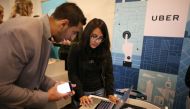 File photo of An Uber recruiter talking to a prospective employee at TechFair LA a technology job fair in Los Angeles (REUTERS / Lucy Nicholson) 