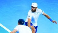 Steve Johnson (top) and Jack Sock (bottom) of the US play a shot against Sam Groth and John Peers of Australia in their doubles match of their world group quarter-final Davis Cup clash at the Pat Rafter Arena in Brisbane.