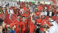 Lekhwiya players celebrate with the Falcon Shield after their last QSL match against Al Shahania on Saturday at Lekhwiya Stadium. 