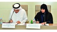 Prof Mariam Al Maadeed and Fahad bin Hamad Almohannadi signing the MoU.