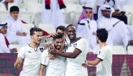Al Sadd players celebrate after Hassan Haydoos (second left) scores their second goal during the first Qatar Cup semi-final against Al Rayyan at Jassim bin Hamad Stadium yesterday. Al Sadd won the match 3-2 to enter the final which will be played on April