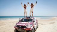 Qatari driver Nasser Saleh Al Attiyah and his French navigator Matthieu Baumel celebrate on the roof of their vehicle after winning the Qatar Cross-Country Rally at Losail yesterday.