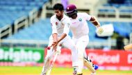 Pakistan's bowler Mohammad Amir (left) stops the ball as West Indies' batsman Shannon Gabriel takes a run on day three of their first Test in Kingston, Jamaica, yesterday. 