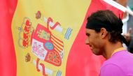 Rafael Nadal of Spain stands near a Spanish flag before his final against his compatriot Albert Ramos-Vinolas at the Monte Carlo Masters. REUTERS/Eric Gaillard
