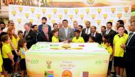 Prof. Shirish Soni (centre), Ambassador of South Africa to Qatar, cutting a cake with South African students and officials of Lulu Group at the opening of South African Food Festival at Lulu Hypermarket in Al Gharrafa, yesterday. Pic: Abdul Basit / The Pe
