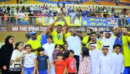 Al Gharafa players celebrate their Emir Cup victory with young fans at the Al Gharafa Indoor Hall on Friday. 