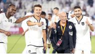 Al Sadd's head coach Jesualdo Ferreira (centre) celebrate along with his players their 2-1 victory over El Jaish in the Qatar Cup final at Al Sadd Stadium on Saturday.