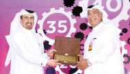 Ali bin Hassan Al-Muraikhi (left), Qatar Steel's Managing Director honouring a long-serving employee at the event.